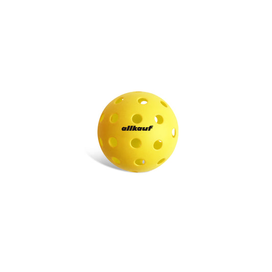 Yellow pickleball with 'allkauf' branding on a white background